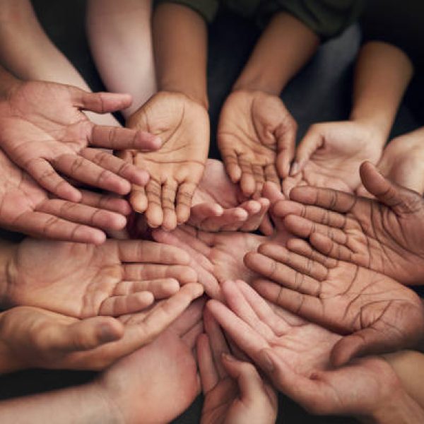 High angle shot of a group of unrecognizable people's hands out with their palms open