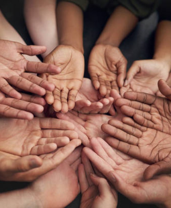 High angle shot of a group of unrecognizable people's hands out with their palms open